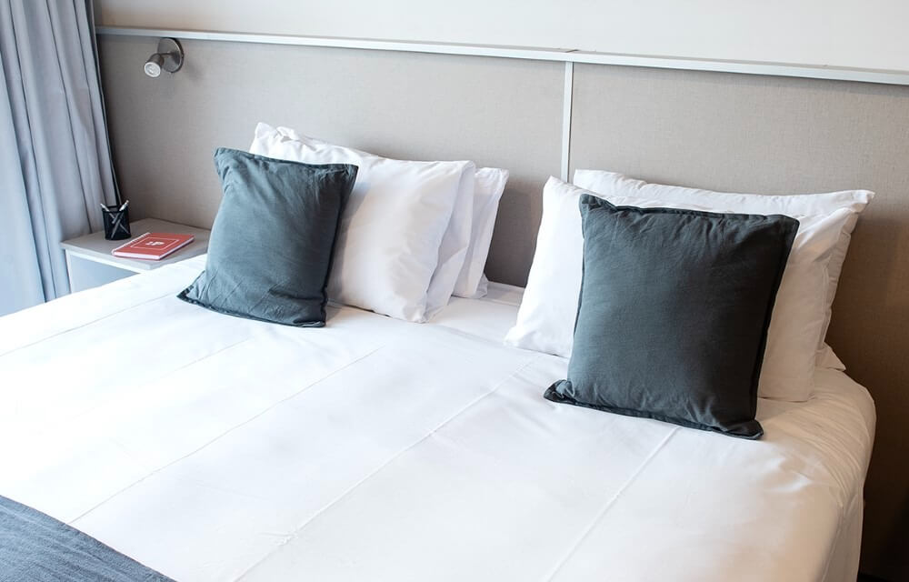 Lit matrimonial dans une chambre de de Filiberto By iPPA, appart hôtel à Buenos Aires